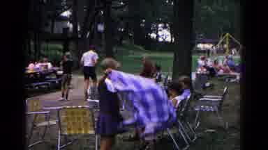 Cold Springs New York USA (1963): Woman Picks Up And Folds Blanket In The Park