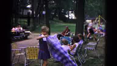 Cold Springs New York USA (1963): Woman Wearing Blue Dress Spreads Out Blue Plaid
