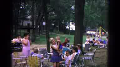 Cold Springs New York USA (1963): Mom Dances With Child In Arms At Gathering With