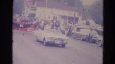 Lincoln Nebraska (1963): White Car Drives Slowly In Front Of Marching Band In