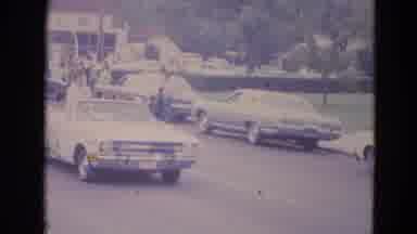 Lincoln Nebraska (1963): Car Drives By In A Parade As A Woman Waves To The