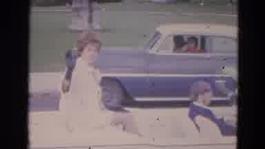 Lincoln Nebraska (1963): Lady Princess Road Driving Driver White Coat Woman Smiles