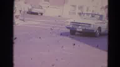 Lincoln Nebraska (1963): Old White Car Driving Down The Road