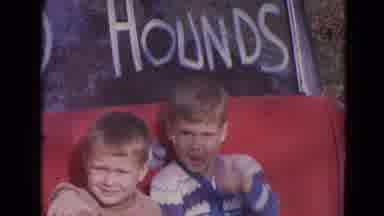 Lincoln Nebraska (1963): Two Kids Standing In Front Of A Car Waving Awkwardly