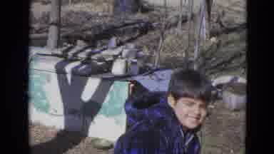 Lincoln Nebraska (1963): Boy Wearing Blue Coat Stands In Front Of Blue And White