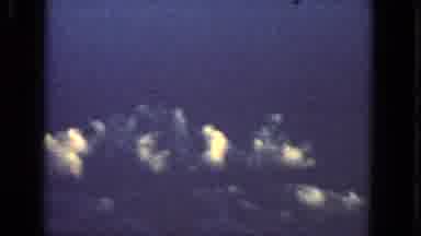San Francisco California-1963: Aerial View of Explosions Over Clouds from Airplane Window