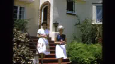 San Francisco California (1963): Two Women In Dresses Descend A Staircase Carrying