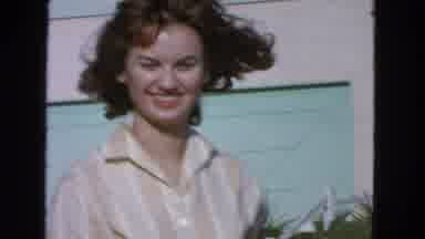 San Francisco California (1963): Smiling Girl In The Foreground Flowers Moved By