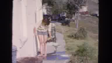 San Francisco California (1963): Girl Filling A Canteen While Looking A Tropical