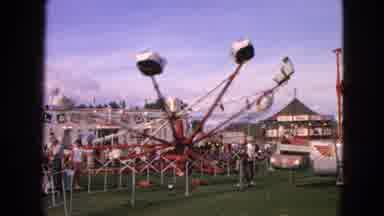 Walworth Wisconsin USA (1963): People Riding In Spinning And Tilting Carnival Ride