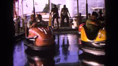 Walworth Wisconsin USA (1963): People In Colourful Bumper Cars Playing In A Fair