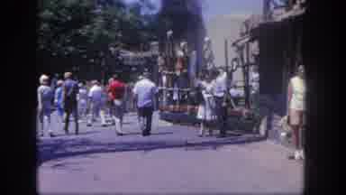Disneyland California (1962): Three People Outdoors On A Busy Street Waving To The