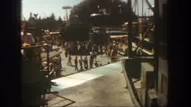 Disneyland California (1962): Crowds Walk Around An Amusement Park With A Fake