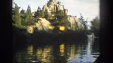 Disneyland California (1962): A Canoe Boat Floats Down A River Towards Some Rocks