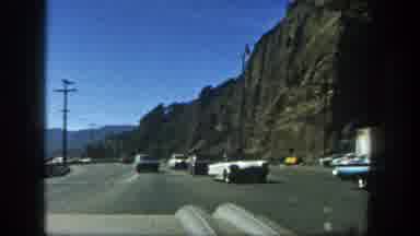 San Diego California (1962): Antique Cars Driving Down The Road That Cuts Through