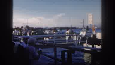 SAN DIEGO CALIFORNIA-1962: Fishing Boat Moving Alongside Dock With Woman Watching