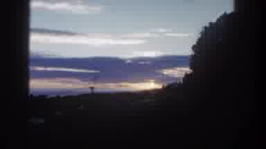 San Diego California (1962): View Of Purple Clouds And Sun Setting Behind Trees At