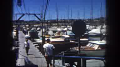 San Diego California (1962): A Man Runs Down To A Dock Boat With Lots Of Boats