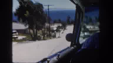 San Diego California (1962): A Driver Steers An Automobile Down A Street On A