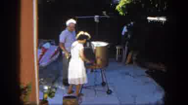 San Diego California (1962): Woman Putting Food On Grill While Man Watches In