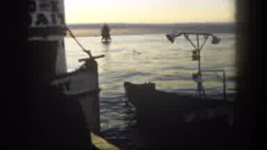 San Diego California (1962): Young Sailor Watches An Empty Jon Boat Floating In
