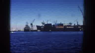 San Diego California (1962): A Large Barge And Many Other Boats Are In Blue Water