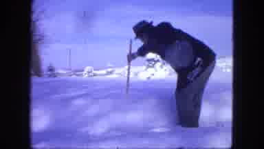 Proctor Minnesota (1963): A Man In A Heavy Coat Measuring The Snow Then Holding Up