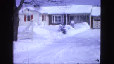 Proctor Minnesota (1963): View Of Blue Car Parked Next To Snow Covered House On A