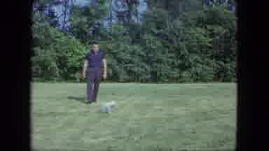 Saint Paul Minnesota (1963): Man Wearing Blue Shirt Pets Small Grey Dog On A Sunny