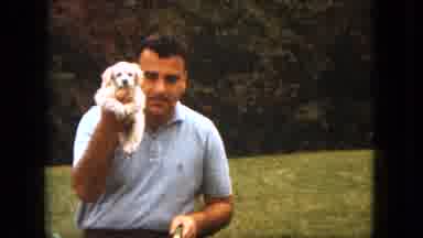 Saint Paul Minnesota (1963): Man Wearing Blue Shirt Holds Small White Puppy While