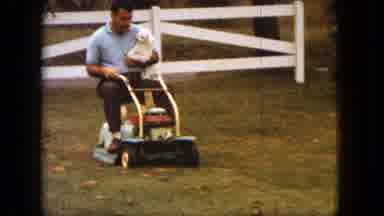 Saint Paul Minnesota (1963): Man Holding A Small White Pet Dog As He Drives A