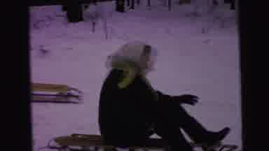 Camden New Jersey (1964): Woman Wearing White Scarf Sleds Downhill On A Clear