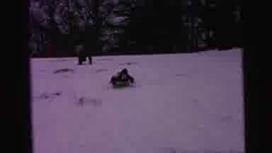 Camden New Jersey (1964): A Young Boy Snowboarding On A Snowy Day While Laughing