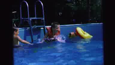 Camden New Jersey (1964): Three Kids Play In A Pool And One Of Them Wearing A Life