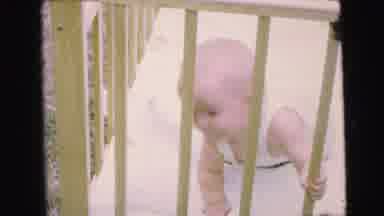 Camden New Jersey (1964): A Baby Tries To Pull Itself Up In A Crib Baby Is Then