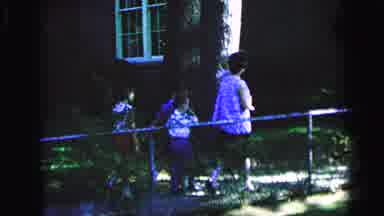 Camden New Jersey (1964): Woman Wearing Blue Dress Turns Boy Wearing White Shirt