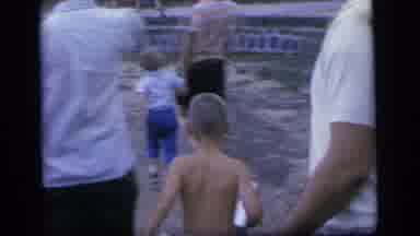 Camden New Jersey (1964): People Throwing Objects Into Pond Water On A Clear Day
