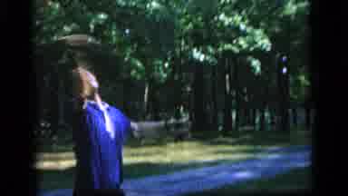 Camden New Jersey (1964): Man Wearing Blue Shirt Throws Object Towards Trees On A