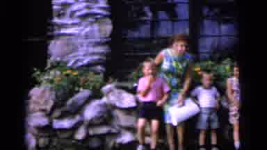 Camden New Jersey (1964): Woman Wearing Green Dress Stands With Kids Next To Stone