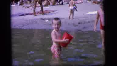 Camden New Jersey (1964): People At A Beach Having Fun Playing In Water While Some