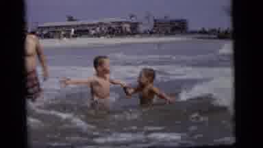 Camden New Jersey (1964): Two Young Children Jumping In The Wave Of A Ocean Coming