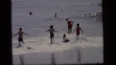 Camden New Jersey (1964): Several Kids Run And Jump Into The Ocean With Waves