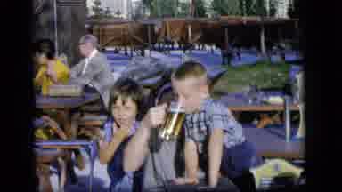 Camden New Jersey US (1964): Mother Letting Her Child Taste Beer At An Outside