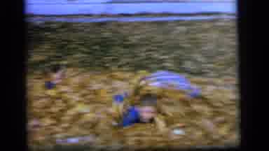 Camden New Jersey US (1964): Four Boys Roll Around In A Pile Of Leaves Wearing