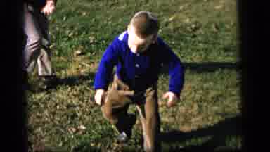 Camden New Jersey US (1964): Boy Wearing Black And White Sweater Tries Catching