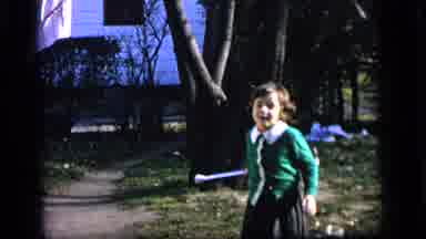 Camden New Jersey US (1964): Little Girl In A Green Sweater Practicing Twirling A