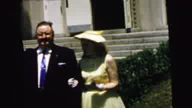 Camden New Jersey USA (1964): Woman Wearing Yellow Dress And Hat Stands Next To