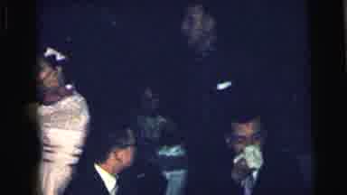 Camden New Jersey USA (1964): Well-Dressed Man Passing By Man Wiping Nose And