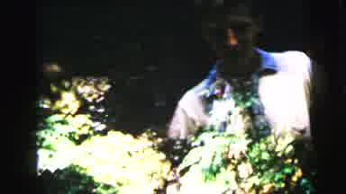 Camden New Jersey USA (1964): Man And Women Rush Arm And Arm Through The Woods