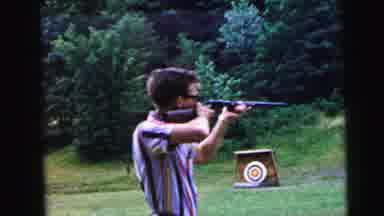 Camden New Jersey USA (1964): Young Man Wearing Glasses Shoots Rifle At Target For